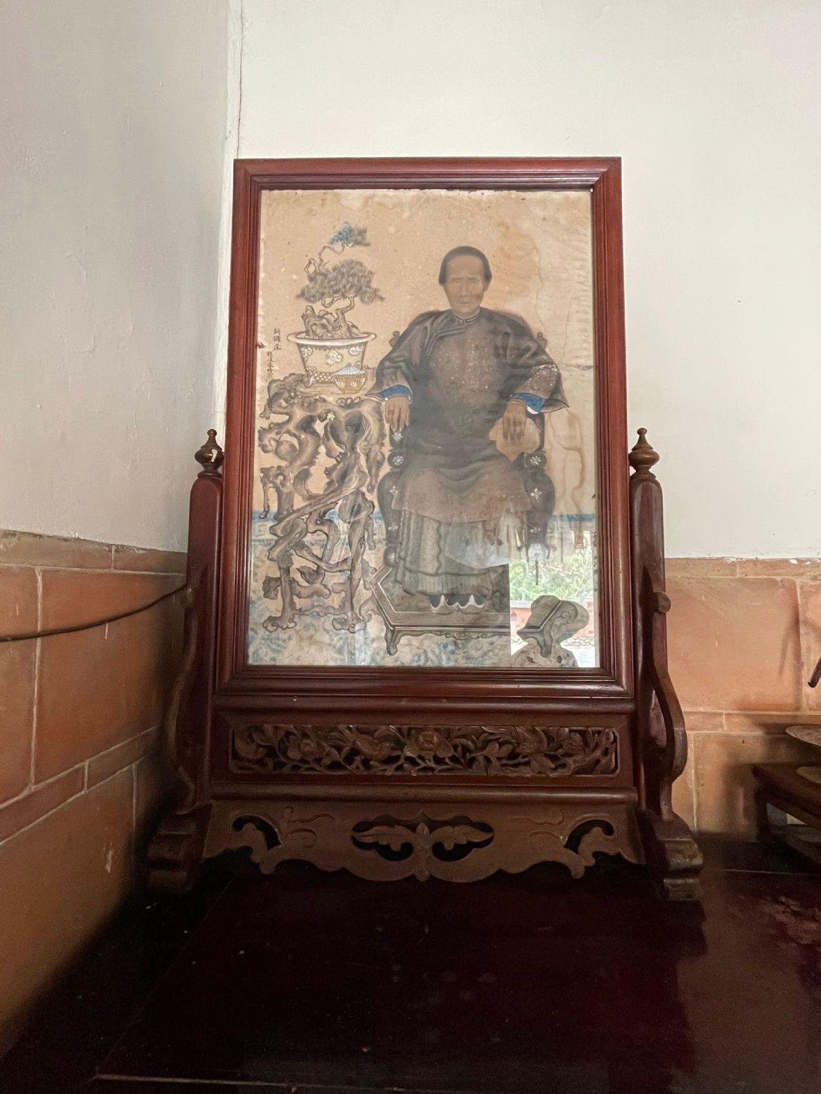 邱屋祖先畫像中邱家祖婆手持手巾，代表有教養